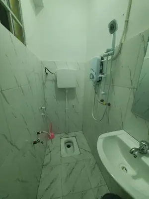 a small bathroom with a sink and a toilet at Ma lo Lounge n Lodge