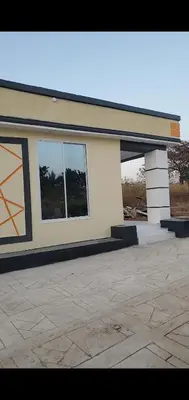 a building with two windows on the side of it at Ma lo Lounge n Lodge