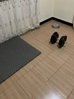 a pair of dumbbells on the floor in a room at Friendly House in Arusha