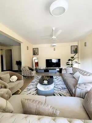 a large living room with couches and a table at Apartment in Arusha City Centre AICC in Arusha