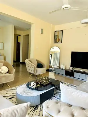 a living room with a couch and a tv at Apartment in Arusha City Centre AICC in Arusha