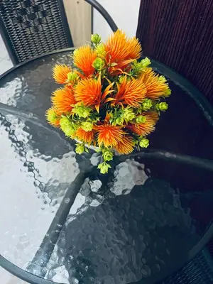 a bouquet of orange flowers sitting on top of a table at Osim Bnb in Arusha