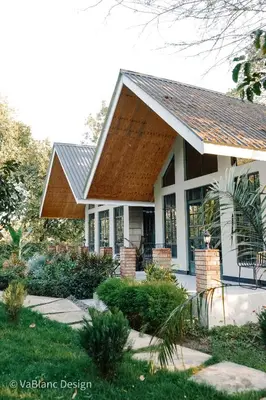 a small house with a gambrel roof at Naishika Home Stay in Tengeru