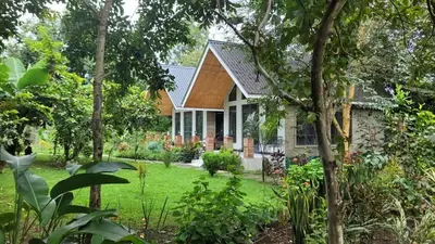 a house with a garden in front of it at Naishika Home Stay in Tengeru