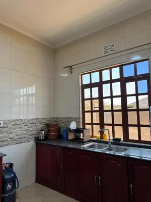 a kitchen with a sink and a window at Oasis HomeStay in Arusha