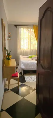 a bedroom with a bed and a window at divine favour homestay in Arusha