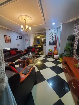 a living room with a black and white checkered floor at divine favour homestay in Arusha