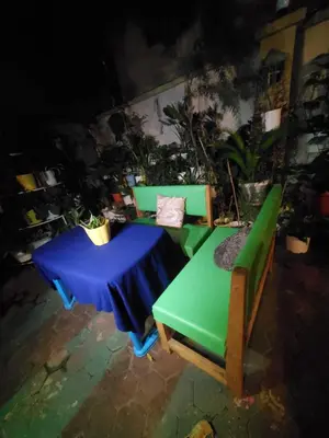 a table and two chairs with a blue and green table at divine favour homestay in Arusha