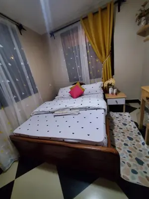 a bedroom with a bed with polka dot sheets at divine favour homestay in Arusha