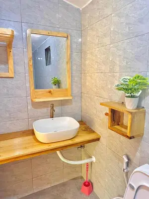 a bathroom with a sink and a mirror at J&T Homestay in Karatu