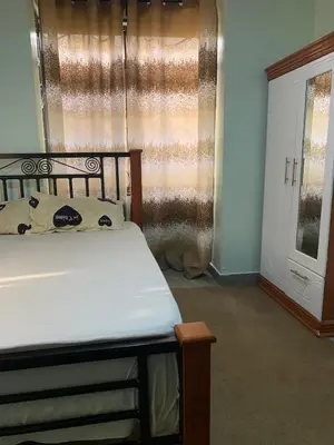 a bedroom with a bed and a window at Datogga Homestay in Kitumbeine