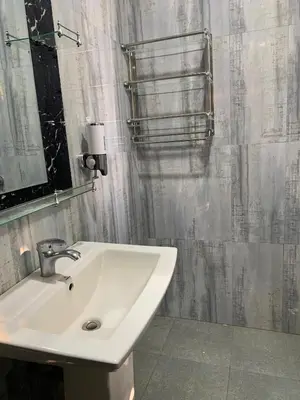 a bathroom with a sink and a shower curtain at Datogga Homestay in Kitumbeine
