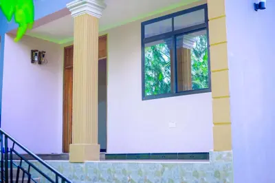 a house with two windows and a staircase at Materuni Home Stay in Uru East
