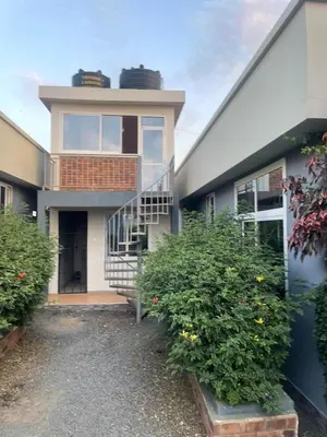 a house with a spiral staircase in front of it at Lavish 2 Bedroom in Arusha