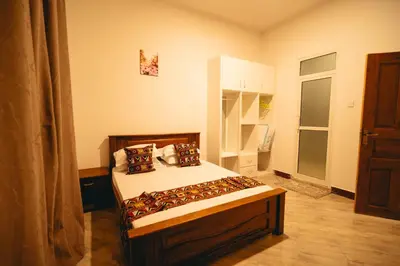 a bedroom with a bed in a room at FREEDOM homes in Arusha