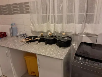 a kitchen counter with four pots and pans on it at FREEDOM homes in Arusha