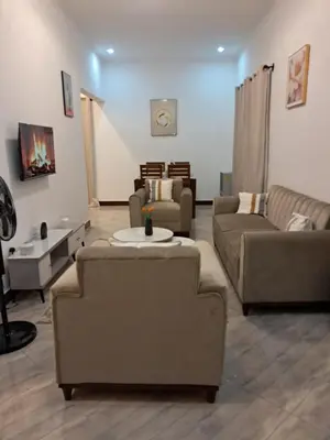 a living room with couches and a couch and a table at FREEDOM homes in Arusha