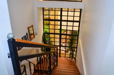 a stairway with a view of a room with plants at Chaga African Home in Moshi