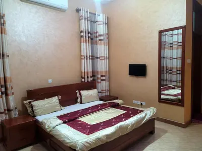 a bedroom with a bed with a mirror and a mirror at Cape Villa in Arusha