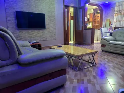 a living room with a couch and a table at Cape Villa in Arusha