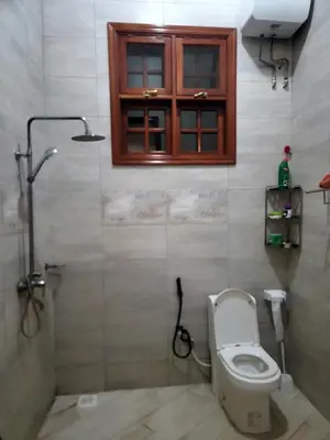 a bathroom with a toilet and a window at Cape Villa in Arusha