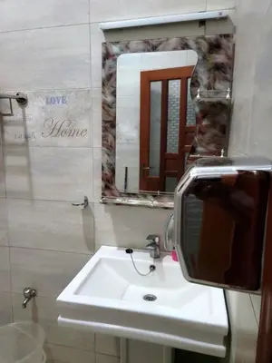 a bathroom with a mirror and a sink at Cape Villa in Arusha