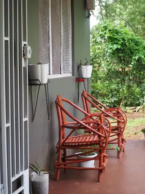two chairs sitting on the porch of a house at freedom house in Msaranga