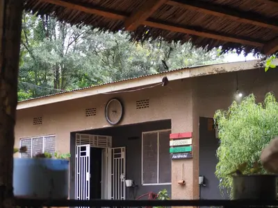 a house with a clock on the side of it at freedom house in Msaranga