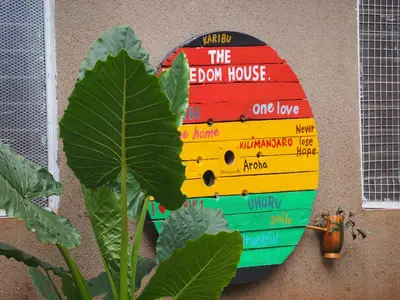 a book sign on the side of a wall at freedom house in Msaranga