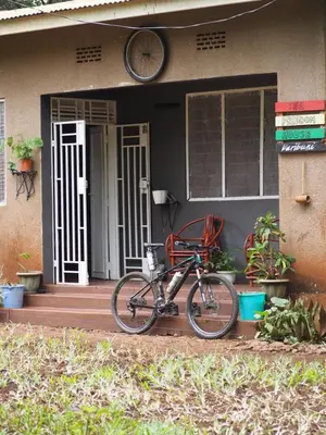 a bike parked on the porch of a house at freedom house in Msaranga