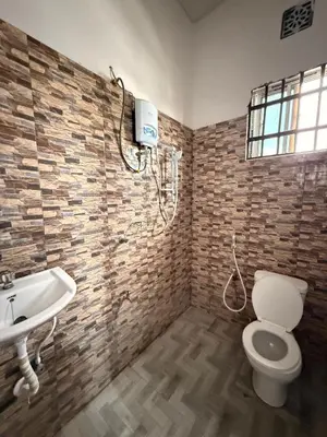 a bathroom with a toilet and a sink at Haven Retreat in Arusha