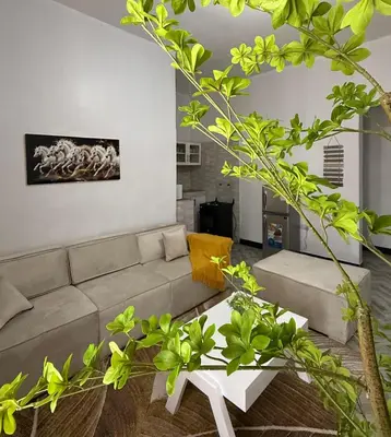 a living room with a couch and a table at Haven Retreat in Arusha