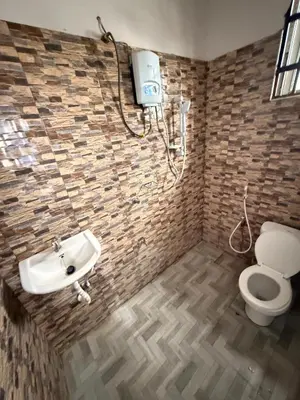 a bathroom with a sink and a toilet at Haven Retreat in Arusha