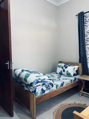 a small bedroom with a bed with at The Black Mamba in Arusha