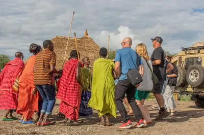 a group of people standing in front of a truck at Naramatisho Women's Centre in Makuyuni
