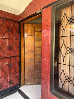 an entrance to a house with red walls and glass doors at Njiro Rented 3 Bedroom House in Themi