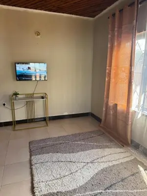a living room with a television and a rug at Njiro Rented 3 Bedroom House in Themi