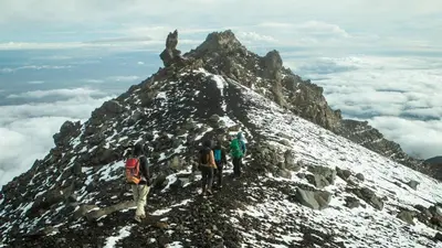 a group of people standing on the side of a mountain at Naibor Villa in Themi