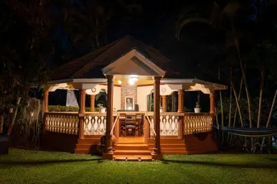 a small gazebo with a porch at night at Naibor Villa in Themi
