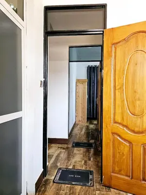 a hallway with a door and a door mat at Kinyanjui's homes 004 in Kirua