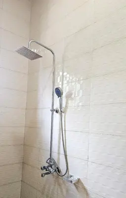 a shower with a shower head in a bathroom at Kinyanjui's homes 004 in Kirua