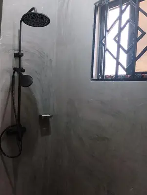 a shower in a bathroom with a window at Nyumbani House in Mto wa Mbu