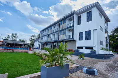a large white building with a yard in front of it at Njiro Luxury in Arusha