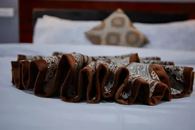a close up of a plate of food on a bed at Njiro Luxury in Arusha