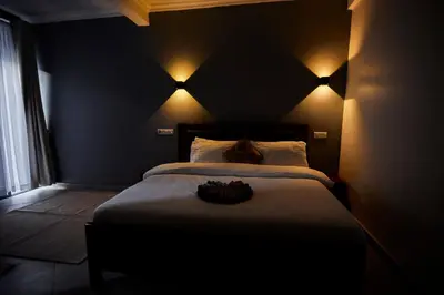 a bedroom with a large bed with lights on it at Njiro Luxury in Arusha