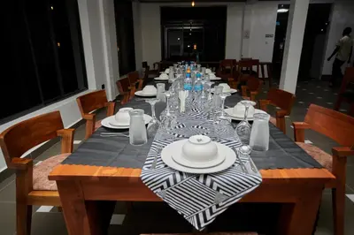 a long table with plates and glasses on it at Njiro Luxury in Arusha