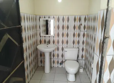 a bathroom with a toilet and a sink at Barrenjourney Africa in Arusha