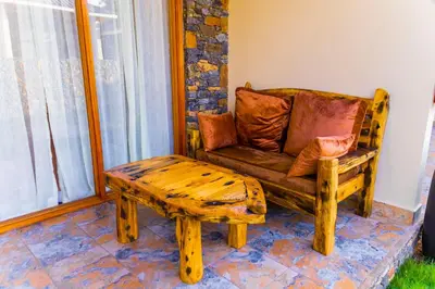 a living room with a couch and a coffee table at Lastanza Safari Lodge in Moshi