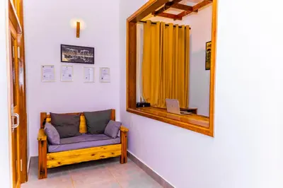 a room with a mirror and a couch with a laptop at Lastanza Safari Lodge in Moshi