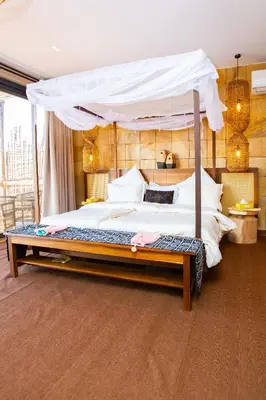 a bedroom with a large bed with a canopy at Shibam Campsite in Naberera